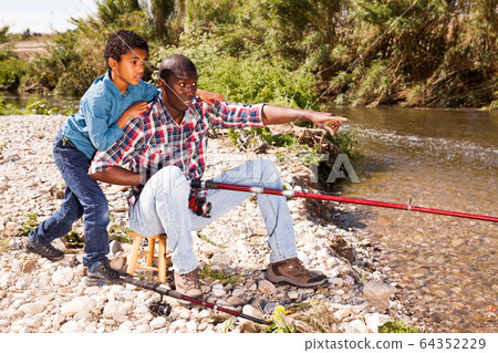 Fishermen - boy and his father Fishermen - boy and his father 64352229