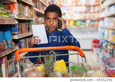 African preteen boy buying food African preteen boy buying food 64352256