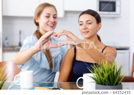 Portrait of two young friendly women Portrait of two young friendly women 64352435