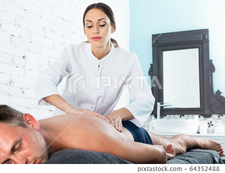 Relaxing professional massage for young man in spa salon 64352488