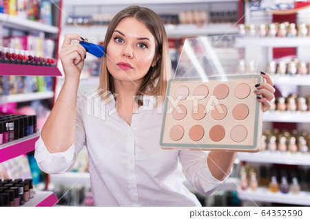 Attractive woman testing powder at store Attractive woman testing powder at store 64352590