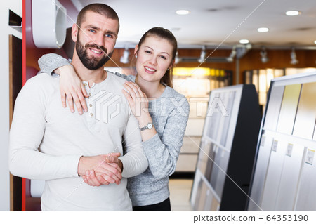 Portrait of couple looking kitchen ceramic tile Portrait of couple looking kitchen ceramic tile 64353190