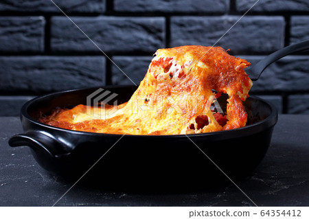 Cannelloni pasta stuffed with beef bolognese sauce 64354412