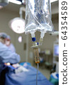 IV drip and heart monitor in hospital operating theatre 64354589