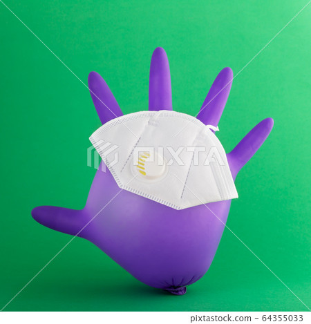 Mask on the medical glove as a symbol of protection Mask on the medical glove as a symbol of protection 64355033