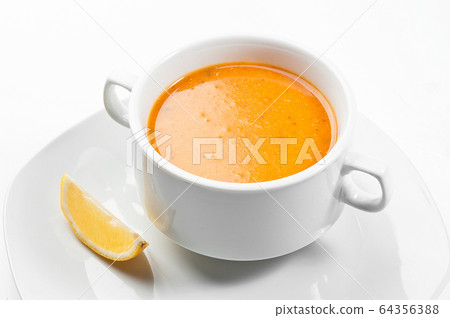 Turkish mercimek corbasi. Turkish lentil soup with a slice of lemon. 64356388