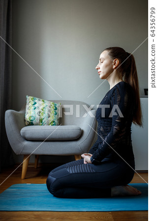Young woman practicing yoga in relaxation pose 64356799