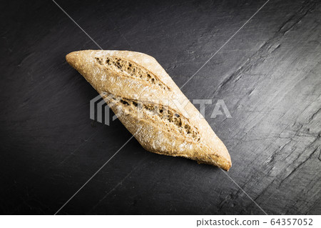 small loaf of whole wheat flour elongated 64357052