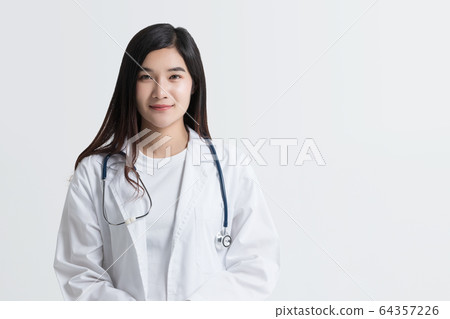 attractive Asian female doctor looking at camera with smiling face, isolated on white background with copy space. studio shot attractive Asian female doctor looking at camera with smiling face, isolated on white background with copy space. studio shot 64357226