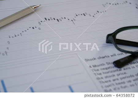 Stock chart and glasses and pen Stock chart and glasses and pen 64358072