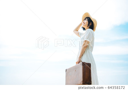 Woman traveling in summer 64358172
