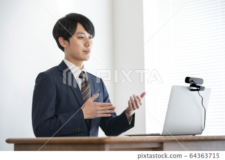 Image of a young male video chat online interview talking to a webcam 64363715