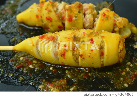grilled squid stuffed egg dressing spicy sauce on plate 64364065