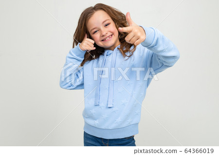 smiling teenage girl in casual blue hoodie shows class on a white background 64366019