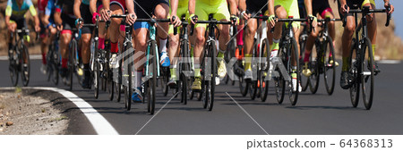 Cycling competition,cyclist athletes riding a race, the peloton climbing the mountain 64368313