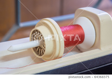 Roll of twine cord on sewing machine Roll of twine cord on sewing machine 64368375