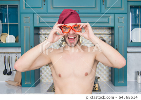 Happy man with red pepper slices like glasses. Happy man with red pepper slices like glasses. 64368614