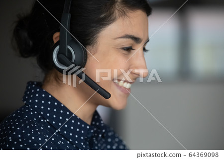Smiling ethnic woman talk on video call with client Smiling ethnic woman talk on video call with client 64369098