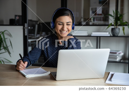 Smiling female worker in headset consult client online 64369230