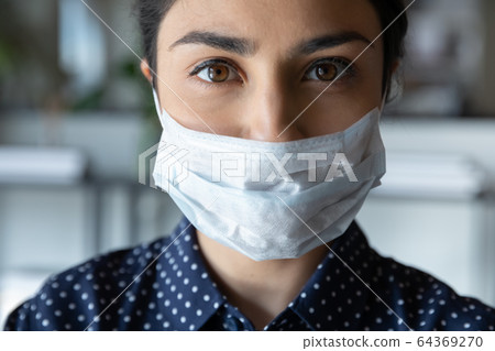 Close up portrait of female in protective face mask 64369270