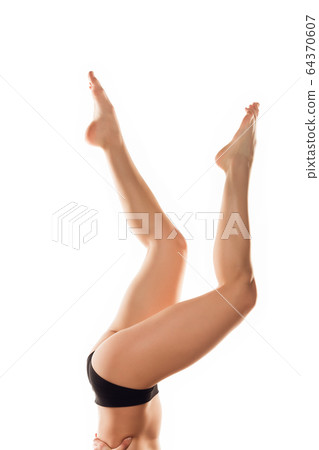Beautiful female legs isolated on white background. Beauty, cosmetics, spa, depilation, treatment and fitness concept, sensual posing Beautiful female legs isolated on white background. Beauty, cosmetics, spa, depilation, treatment and fitness concept, sensual posing 64370607