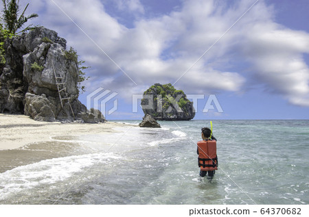 The image behind Asian Boy wearing a life jacket and scuba diving in the sea at koh Lankajiu 64370682