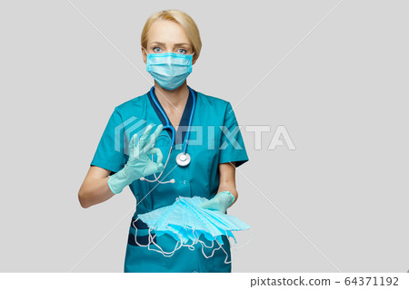 medical doctor nurse woman with stethoscope over light grey background - showing protective mask medical doctor nurse woman with stethoscope over light grey background - showing protective mask 64371192