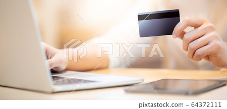 Male customer hand using credit card for online 64372111