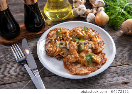 Tasty homemade potato pancakes with meat and Tasty homemade potato pancakes with meat and 64372151