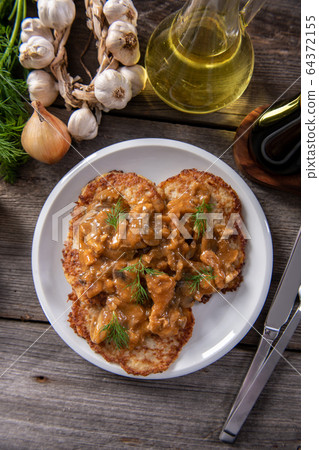 Tasty homemade potato pancakes with meat and Tasty homemade potato pancakes with meat and 64372155