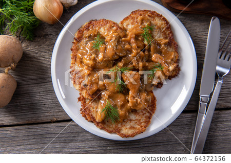 Tasty homemade potato pancakes with meat and Tasty homemade potato pancakes with meat and 64372156