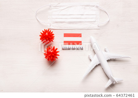 Plane model and face mask and flag Austria. Coronavirus pandemic. Flight ban and closed borders for tourists and travelers with coronavirus covid-19 from Europe and Asia. Plane model and face mask and flag Austria. Coronavirus pandemic. Flight ban and closed borders for tourists and travelers with coronavirus covid-19 from Europe and Asia. 64372461