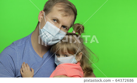 Sick father and daughter in medical mask. Coronavirus concept. Family quarantine Sick father and daughter in medical mask. Coronavirus concept. Family quarantine 64372686
