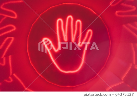 silhouette of hands on light up LED touchscreen table. 64373127