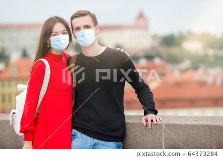 Happy tourist couple traveling on Charles Bridge in Prague 64373284
