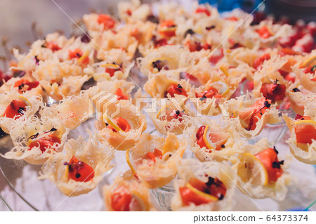 Fresh Assorted snacks of canape on the table. Fresh Assorted snacks of canape on the table. 64373374