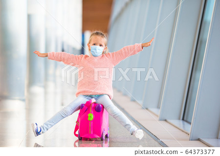 Little kid in airport waiting for boarding Little kid in airport waiting for boarding 64373377