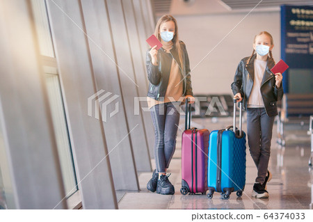 Little kid in airport waiting for boarding Little kid in airport waiting for boarding 64374033