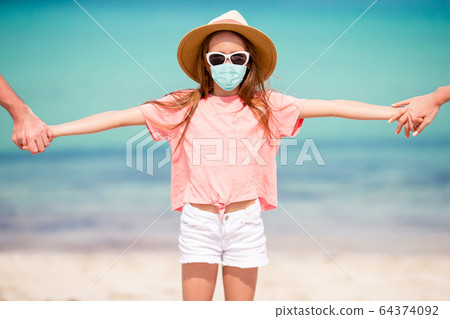 Adorable little girl have fun at tropical beach during vacation Adorable little girl have fun at tropical beach during vacation 64374092