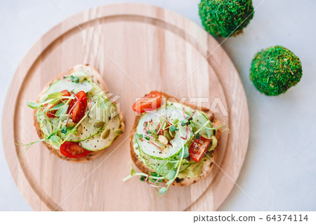 Tasty italian bruschetta on the wooden plate 64374114