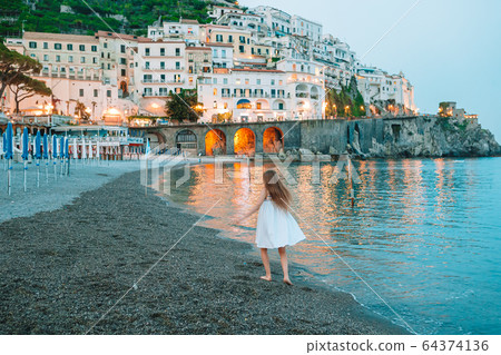 Adorable little girl on sunset in Amalfi town in Italy Adorable little girl on sunset in Amalfi town in Italy 64374136
