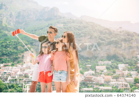 Parents and kids taking selfie photo background Positano town in Itali on Amalfi coast Parents and kids taking selfie photo background Positano town in Itali on Amalfi coast 64374140