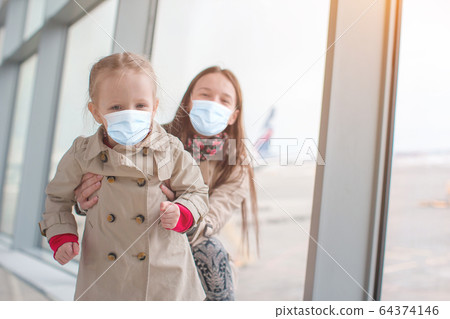 Family of mom and kid at airport waiting for boarding Family of mom and kid at airport waiting for boarding 64374146