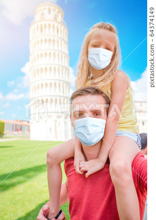 Family portrait background the Learning Tower in Pisa. Pisa - travel to famous places in Europe. 64374149