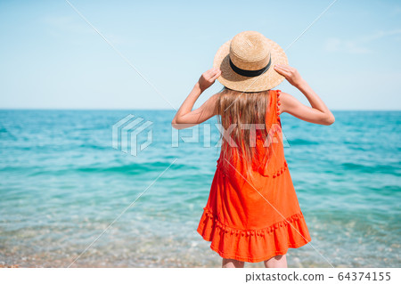 Cute little girl at beach during summer vacation Cute little girl at beach during summer vacation 64374155