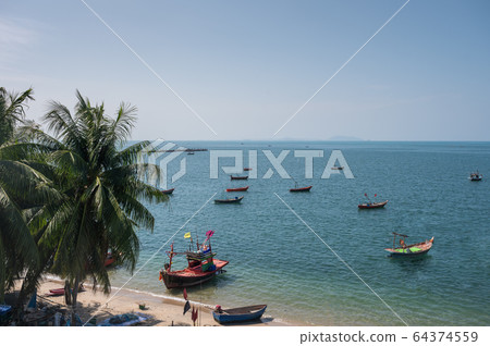 Tropical sea with coconut trees and fishing boat Tropical sea with coconut trees and fishing boat 64374559