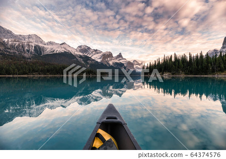 Canoeing on Maligne lake with canadian rockies 64374576