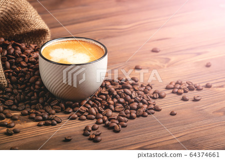 White coffee cup. Roasted coffee beans. White coffee cup. Roasted coffee beans. 64374661