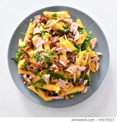 Penne pasta with tuna chunks, rucola and dry Penne pasta with tuna chunks, rucola and dry 64375017