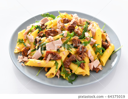 Penne pasta with tuna chunks, rucola and dry Penne pasta with tuna chunks, rucola and dry 64375019